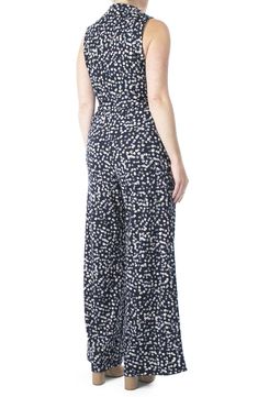 Sleek, artistic graphic prints accentuate a surplice neckline jumpsuit for an en vogue, chic attire. - Surplice neck with spread collar- Sleeveless- Waist tie- 2 front slash pockets- Allover print- Approx. 62" length, 30" inseam (size M)- ImportedAvailable in:- Polka dot print (BLACK-IVORY, NAVY-IVORY)- Floral print (NAVY MULTI)- Geo print (BLACK/ WHITE) Model's stats for sizing:. Height: 5'10". Bust: 34". Waist: 24". Hips: 34" Model is wearing size S. Machine wash cold 95% polyester, 5% spandex Chic Wide Leg Jumpsuits And Rompers With Floral Print, Chic Strapless Sleeveless Jumpsuit With Elastic Waistband, Casual Strapless Sleeveless Jumpsuit With Tie Waist, Elegant Sleeveless Printed Jumpsuits And Rompers, Elegant Printed Sleeveless Jumpsuits And Rompers, Spring Strapless Sleeveless Jumpsuit With Tie Waist, Chic Floral Jumpsuits And Rompers For Work, Strapless Sleeveless Jumpsuit With Tie Waist For Spring, Elegant Floral Print Jumpsuits And Rompers For Work