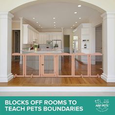 an open kitchen and living room area with wooden flooring, white walls and cabinets