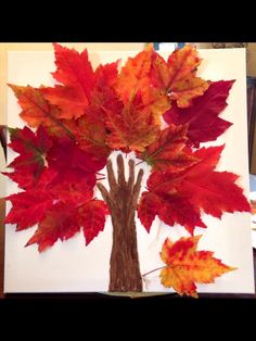 a tree made out of leaves on top of a white board