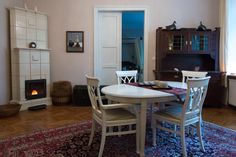 a dining room table with chairs and a fire place