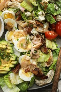 a salad with hard boiled eggs, bacon and lettuce