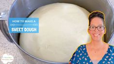 a woman standing in front of a metal pan filled with dough and smiling at the camera