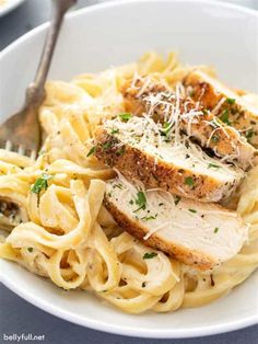 a plate of pasta with chicken and parmesan cheese