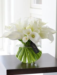 a vase filled with white flowers on top of a table