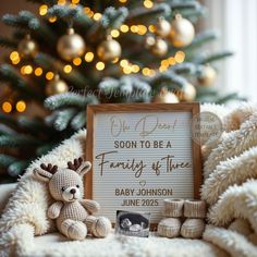 a teddy bear sitting next to a sign with a baby's birth date on it