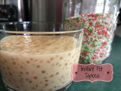 a close up of a dessert in a glass on a table next to a crock pot