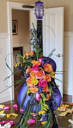 an arrangement of flowers is displayed on the floor