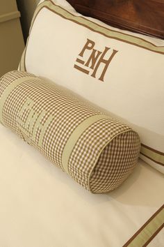 a pillow that is on top of a bed with the initials hn and hn