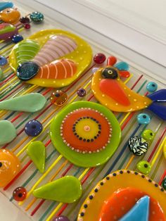 there are many colorful plates on the table