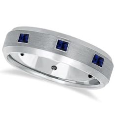 a white gold ring with blue sapphire stones