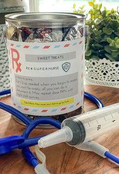 a canister filled with candies next to a stethoscope on a table