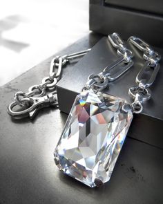 "All eyes on YOU! This head-turning, absolutely-FREAKING-FABulous crystal pendant necklace has the most dazzlingly brilliant sparkle! This exceptionally faceted crystal is suspended from shiny, silver-plated, large-link geometric chain that feels downright regal as it rests on your collarbones. Feel like a million bucks, baby! -Large, exceptionally-faceted premium rectangular crystal: 1-7/16\" tall x 1\" wide (36mm x 24mm) -Antiqued silver plated bezel -Shiny distressed silver plated thick chain Crystal Point Necklace, Modern Jewellery Design, Queen Jewelry, Crystal Pendant Necklace, Large Crystal, Crystal Skull, Crystal Necklace Pendant, Pinky Ring, Large Crystals