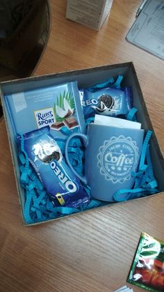 a coffee cup and some snacks in a box