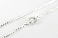 A brilliant clear crystal twinkles on dainty yet strong sterling silver chains to create this gorgeous modern necklace. The crystal measures 8mm in size. It is bezel set in 925 sterling silver. The crystal has been perfectly faceted on both sides giving the stone absolutely incredible sparkle, catching the light at any angle. This necklace is made to order. Please choose your desired length upon checking out. Not quite sure? Just select an adjustable length to be sure you get the perfect fit. Th Elegant White Sterling Silver Crystal Necklaces, Elegant White Crystal Necklace In Sterling Silver, Elegant White Sterling Silver Crystal Necklace, Adjustable Elegant Sterling Silver Crystal Necklace, Elegant Adjustable Sterling Silver Crystal Necklace, Delicate Round Silver Crystal Necklaces, Delicate Round Silver Crystal Necklace, Delicate Silver Crystal Necklace With Adjustable Chain, Elegant Sterling Silver Crystal Necklace With Adjustable Chain