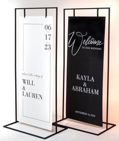 two black and white wedding signs on display