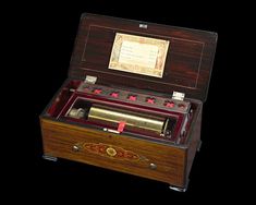 an old fashioned wooden box with writing on the inside and in it's lid