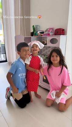 three children are posing in front of an oven