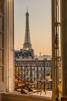 the eiffel tower is seen through an open window