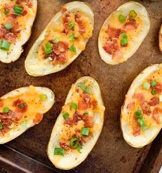 baked potato skins with bacon and green onions on a baking sheet, ready to be eaten