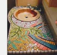 a bathroom sink with a mosaic design on it