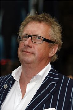 a man wearing glasses and a striped jacket