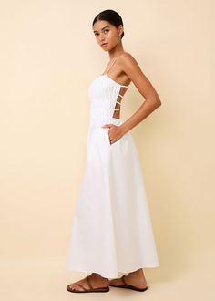 Our bestselling Delta Midi Dress is back in Optic White. The smocked bodice with a relaxed skirt offers a flattering fit for all figures. This silhouette offers adjustable straps, pockets, and an exposed back with elastic straps for optimal fit. Fitted Bodice Dress With Adjustable Straps For Day Out, Midi Dress With Smocked Back For Day Out, Midi Dress With Spaghetti Straps And Smocked Back, Casual Midi Dress With Smocked Back And Spaghetti Straps, Spaghetti Strap Maxi Dress With Ruched Bodice For Daywear, Daywear Spaghetti Strap Dress With Smocked Back, Vacation Dress With Adjustable Straps And Fitted Bodice, Daywear Dresses With Smocked Bodice And Spaghetti Straps, Chic Maxi Dress With Adjustable Straps And Fitted Bodice