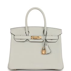 This Birkin is in Gris Neve togo leather with gold hardware and has tonal stitching, front flap, two straps with center toggle closure, clochette with lock and two keys, and double rolled handles.The interior is lined with Gris Neve chevre and has one zip pocket with an Hermes engraved zipper pull and an open pocket on the opposite side.Collection: BOrigin: FranceCondition: Pristine; new or never worn (Plastic on hardware)Accompanied by: Hermes box, Hermes dustbag, clochette, lock, two keys, clochette dustbag, felt, carebook and ribbonMeasurements: 11.75" width x 9.5" height x 6" depth; 4.25" handle drop Timeless Togo Leather Bag With Gold-tone Hardware, Classic Togo Leather Bag With Gold-tone Hardware, Luxury Everyday Calf Leather Bag With Lock, Designer Togo Leather Bag With Metal Hardware, Timeless Togo Leather Bag With Lock, Timeless Bags With Metal Hardware And Togo Leather, Timeless Togo Leather Bag With Metal Hardware, Luxury Calf Leather Bag With Lock, Elegant Togo Leather Bag With Gold-tone Hardware