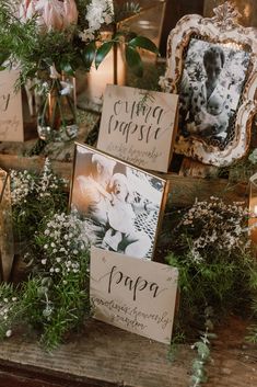 some pictures and flowers on a table with candles