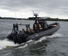 a black boat with two men in it