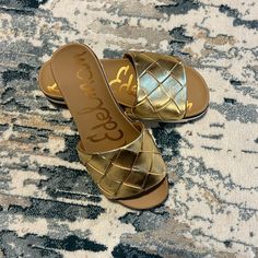 Brand New Sam Edelman Gold Slip On Sandals. Never Worn. Size 6 Gold Synthetic Slides For Beach, Casual Gold Slides For Vacation, Gold Synthetic Slides With Cushioned Footbed, Gold Round Toe Slides For Spring, Gold Synthetic Slides For Vacation, Gold Flat Mules For Spring, Casual Gold Synthetic Slides, Gold Leather Beach Slides, Gold Flat Slides For Summer