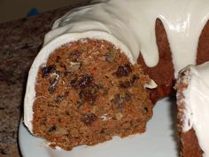 a bundt cake with white frosting on top and carrots in the middle