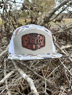 Mama Tried Duck Camo Flatbill SnapBack, with a saddle brown leatherette patch on a Lost Hat Co snapback. You wont be disappointed. ROCK YOUR FAVORITE SNAPBACK!! Shop more at evergladesdesignco.etsy.com Patches made from synthetic leather similar to your cars seats for durability and engraved with a crisp design and pressed on our most popular style of hat with our bull proof adhesive! Your friends are going to be jealous! No Set up fees, Multiple hat colors available. Bulk pricing available & custom shape patches available upon request. Need a custom design with your brand, company logo or event? No problem! Feel free to message us for details and pricing for bulk orders. Hat Patch Ideas, Trucker Snapback Hat For Country Events, Western Snapback Trucker Hat For Country Events, Adjustable Snapback Trucker Hat For Hunting, Adjustable Snapback Trucker Hat For Western-themed Events, Hunting Hats, Western-themed Snapback Trucker Hat, Mama Hat, Mama Tried