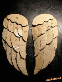 two cardboard angel wings with numbers on them