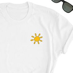 Sun Shirt, Sun Lover T-Shirt, Cute Sun Icon Tee Shirt, Beach Summer Gift Shirt, Sun Tee Shirt, Gift for Summer Lover, Sunshine UNISEX Adult Shirt, Gift for Sunshine Friend Friends will love it! This t-shirt feels soft and lightweight, with the right amount of stretch. It's comfortable and flattering for both men and women.  * 100% cotton (heather colors contain polyester) * Fabric weight: 5 oz  * Shoulder-to-shoulder taping * Side-seamed Time for Delivery: * Processing & production time is 1-6 b Simple Summer T-shirt With Letter Print, White Crew Neck Summer Shirt, White Funny Print Summer T-shirt, White Summer Shirt With Screen Print, Simple White Summer Shirt, Cute Summer T-shirt With White Print, Cute White Print T-shirt For Summer, Sunshine Friend, Sun Icon