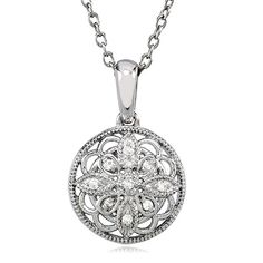 This vintage-inspired sterling silver design has an old fashioned elegance that never goes out of style. The 15mm circle blossom features an open motif infused with nine white diamonds and finished with milgrain detailing. It includes a sterling silver cable chain finished with a spring ring clasp. Each round cut diamond is I2 in clarity and G-H in color. Total diamond weight is .05 of a carat. Classic Diamond White Flower Shaped Jewelry, Silver Medallion Jewelry With Single Cut Diamonds, Classic Medallion Jewelry With Diamond Accents, Timeless Round Filigree Jewelry, Silver Flower Pendant Jewelry With Single Cut Diamonds, Classic Filigree Round Pendant Jewelry, Vintage Silver Jewelry With Pave Setting, Vintage Round Jewelry With Pave Setting, Classic Jewelry With Intricate Round Pendant