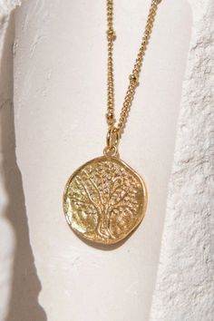 Inspiration : representing the tree of life - it symbolizes strength as a tree is the result of years of slow, patient growth. 24K sustainable gold plated pendant and chain (gilding : satin) Water resistant No risk of allergy (nickel-free, lead-free) Delivered in a vegan leather pouch with its gift box Length : 40 cm (15.7") + 10 cm extender (3.9") - diameter : 16 mm Ethically made in France The Tree Of Life, Leather Pouch, Modern Fashion, The Tree, A Tree, Tree Of Life, Vegan Leather, Gold Plate, Gift Box