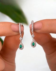 Discover the elegance of our Teardrop Emerald Dangle Earrings, meticulously crafted from 925 sterling silver and adorned with sparkling CZ gemstones. These earrings make a stunning accessory for any occasion and are a perfect gift for bridesmaids. Elegant teardrop design featuring emerald-green CZ gemstones Crafted from high-quality 925 sterling silver for durability and shine. Lightweight and comfortable for all-day wear Ideal gift for bridesmaids, birthdays, anniversaries, or any special occas Green Jewellery, Christmas Cookies Decorated, Green Jewelry, Custom Name Necklace, Pretty Gift, Silver Drop Earrings, Beautiful Gift Boxes, Name Necklace, Emerald Green