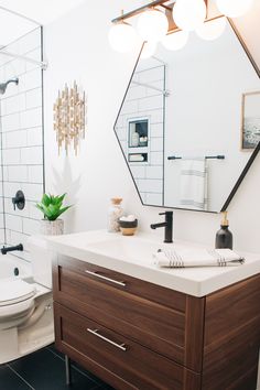 a bathroom with a sink, mirror and toilet