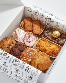 a box filled with lots of different types of cookies and muffins on top of each other