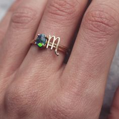 Handmade stacking ring set featuring Scorpio symbol and 4-prong set black opal in 14k gold. Two separate rings built to be worn together or separately. Precision-cut Scorpio symbol is mounted on one round-wire band, the other boasts an oval stone mounted on a 4-prong setting. The setting has a hidden notch to accommodate the Scorpio ring band, so they sit flush when worn together. Pictured is a perfect 3pt oval black opal cabochon, the October birthstone. Request customization for a different st Stackable 14k Gold Opal Ring As Gift, 14k Gold Stackable Opal Ring For Gift, Stackable Opal Ring In 14k Gold For Gift, Zodiac Sign Ring Jewelry Gift, Zodiac Sign Ring For Anniversary, Zodiac Sign Anniversary Ring Jewelry, Zodiac Sign Anniversary Ring, Adjustable Zodiac Sign Jewelry For Anniversary, Stackable May Birthstone Jewelry For Birthday