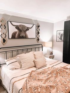 a bedroom with a bed, nightstands and pictures on the wall above it's headboard