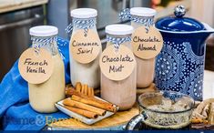 some cinnamons are sitting on a table next to jars with labels that say french vanilla