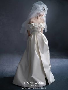 a woman in a white wedding dress with a veil on her head and the words fairy land written below it