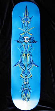 a blue skateboard with an artistic design on it