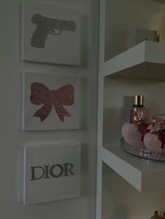 the wall is decorated with pink and silver items, including soaps and perfume bottles