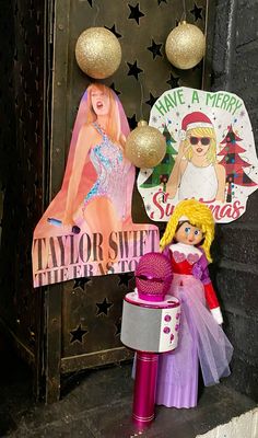 there is a doll next to a sign that says taylorsweet and other decorations