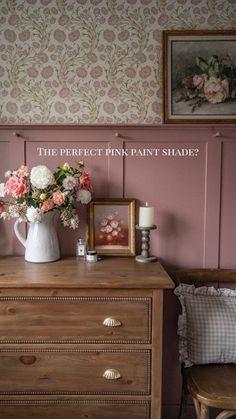 a dresser with pink paint and flowers on it, next to a framed photograph that says the perfect pink paint shade