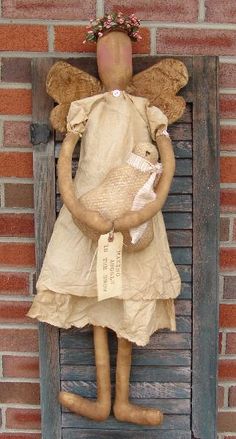 an old doll is hanging on the wall