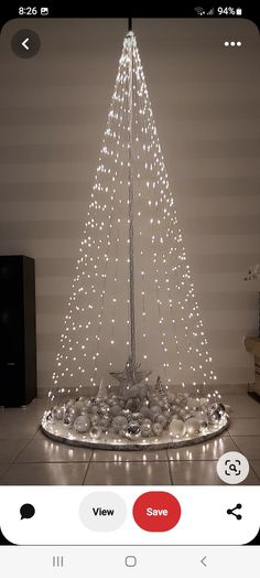 a white christmas tree with lights on it