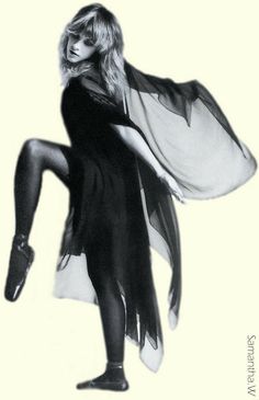 a black and white photo of a woman with her legs spread out in the air